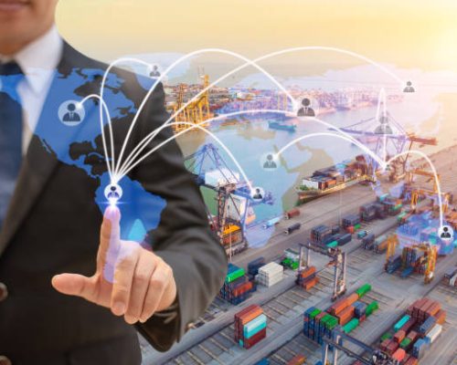 Businessman touching icon people on earth world map for network connection,on Logistics and transportation of International Container Cargo ship in the ocean background,Transportation, Shipping.