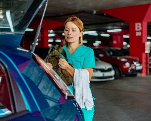 Young nurse efficiently packs her car with all the supplies she'll need for a day of healthcare work