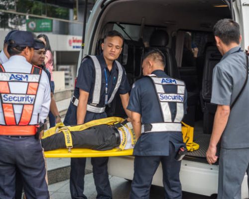 Bangkok, Thailand - November 30, 2017 : Many working people preparedness for fire drill or other disaster by move injury patient on spine board at office in Bangkok Thailand