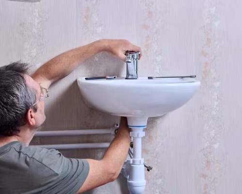 plumbing-work-installing-new-water-faucet-toilet-plumber-is-tightening-nut-that-secures-tap_351981-4461